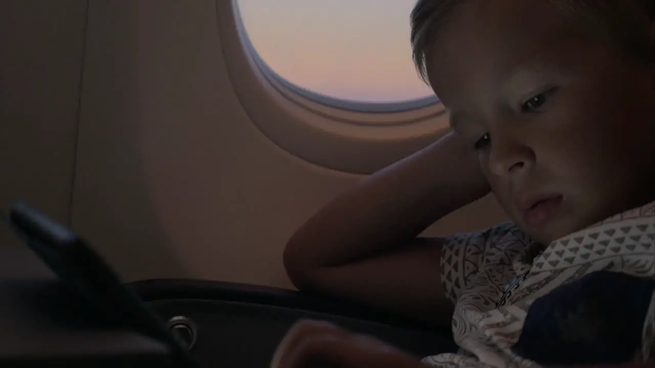 Child using tablet PC in airplane