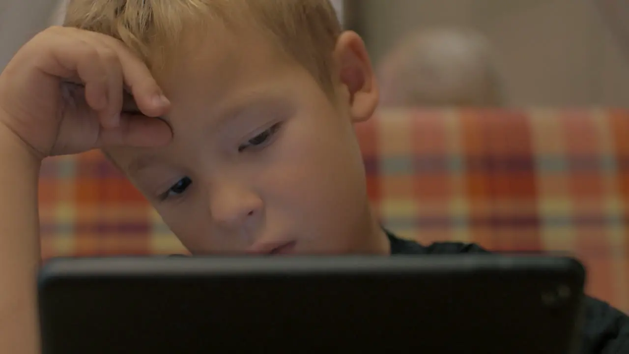 Boy spending leisure time with tablet PC