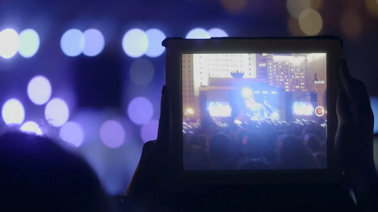 In MSU Moscow on a concert We are together of musical group Kino young girl records video on the tablet