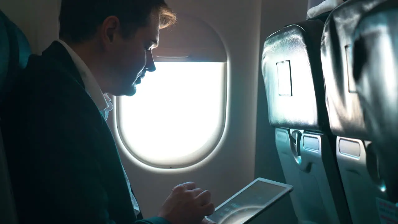 Man using tablet computer during the flight