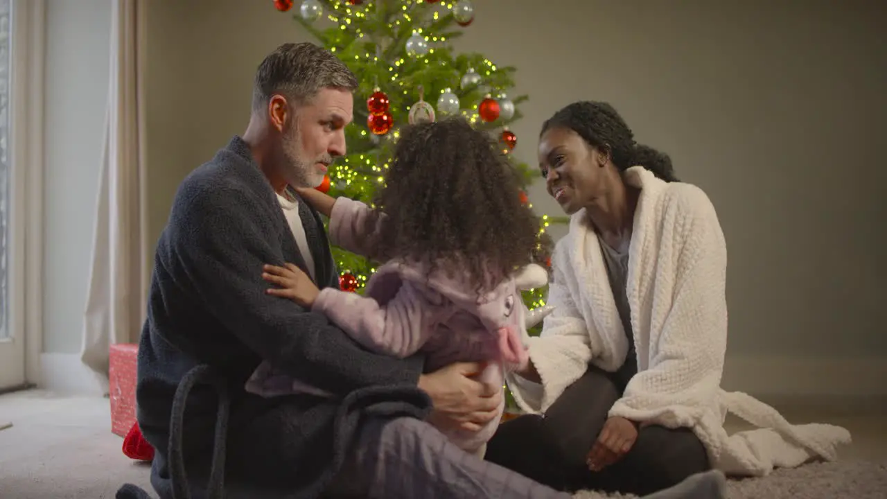 Family Sat Around Christmas Tree