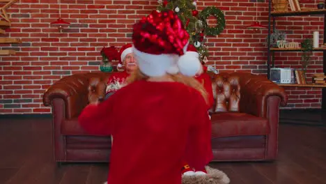 Girl set timer on mobile phone taking multigenerational family selfie portrait celebrating Christmas