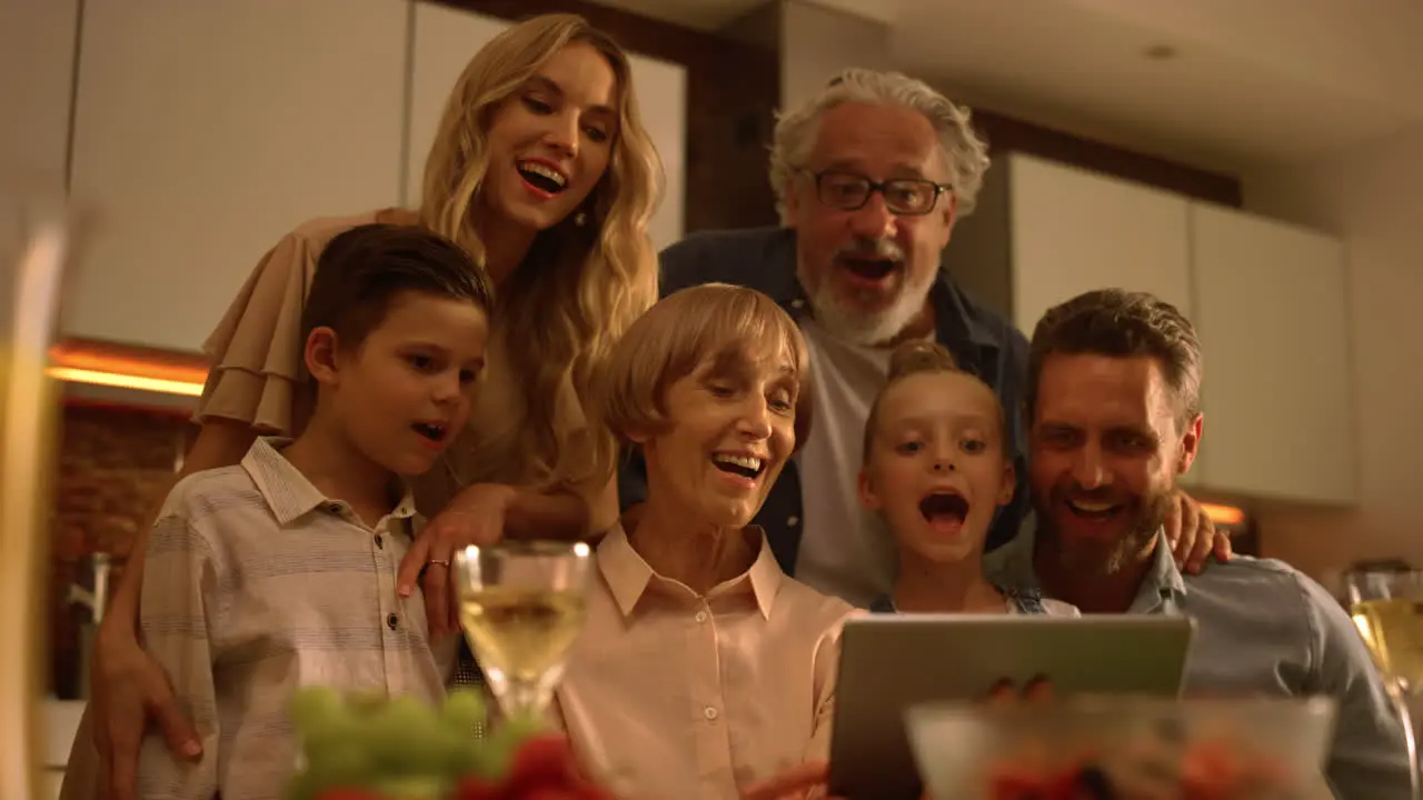 Cheerful family using tablet at home