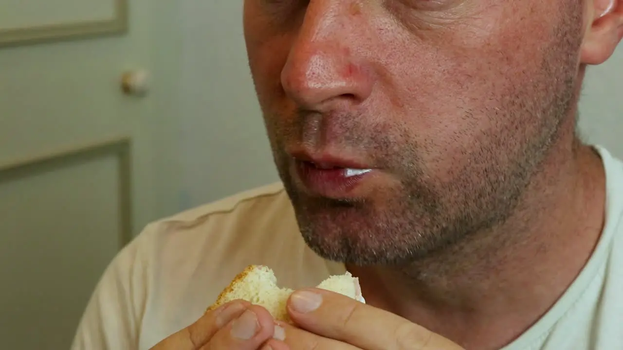 A man eating a sandwich close up