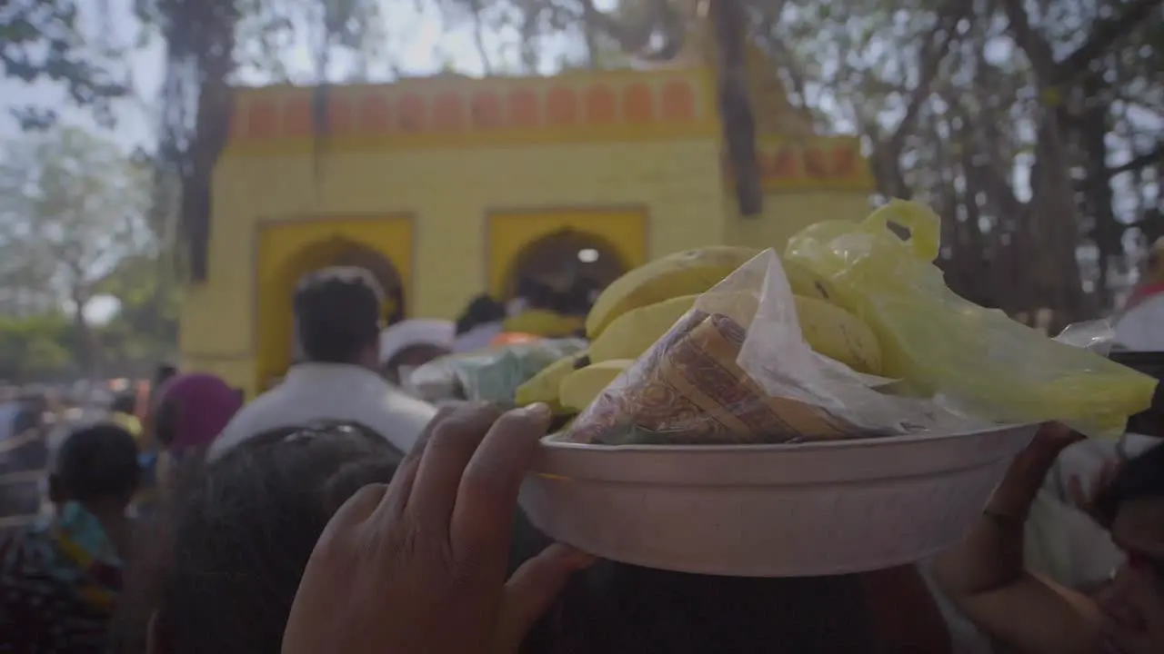 girl offers prasad to the god