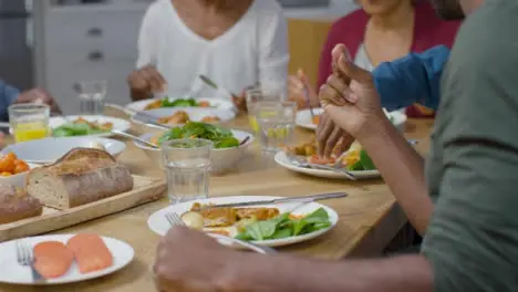 Family Around Table Eating Evening Meal Together