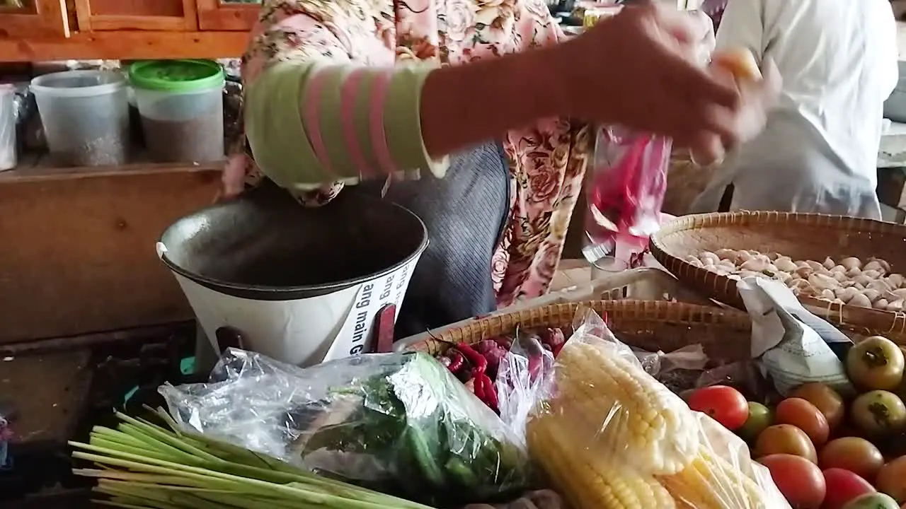 Asian traditional vegetable market Traders wrap chilies tomatoes