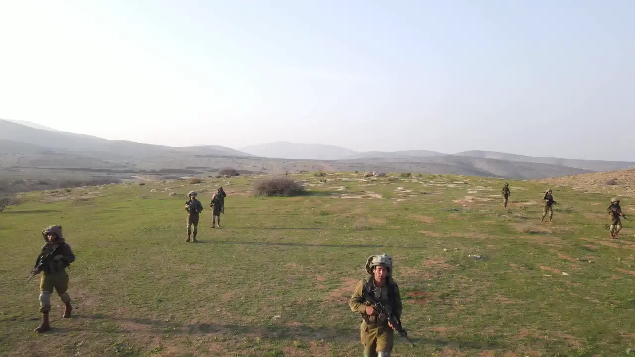 Soldiers walking in formation on the field aerial view