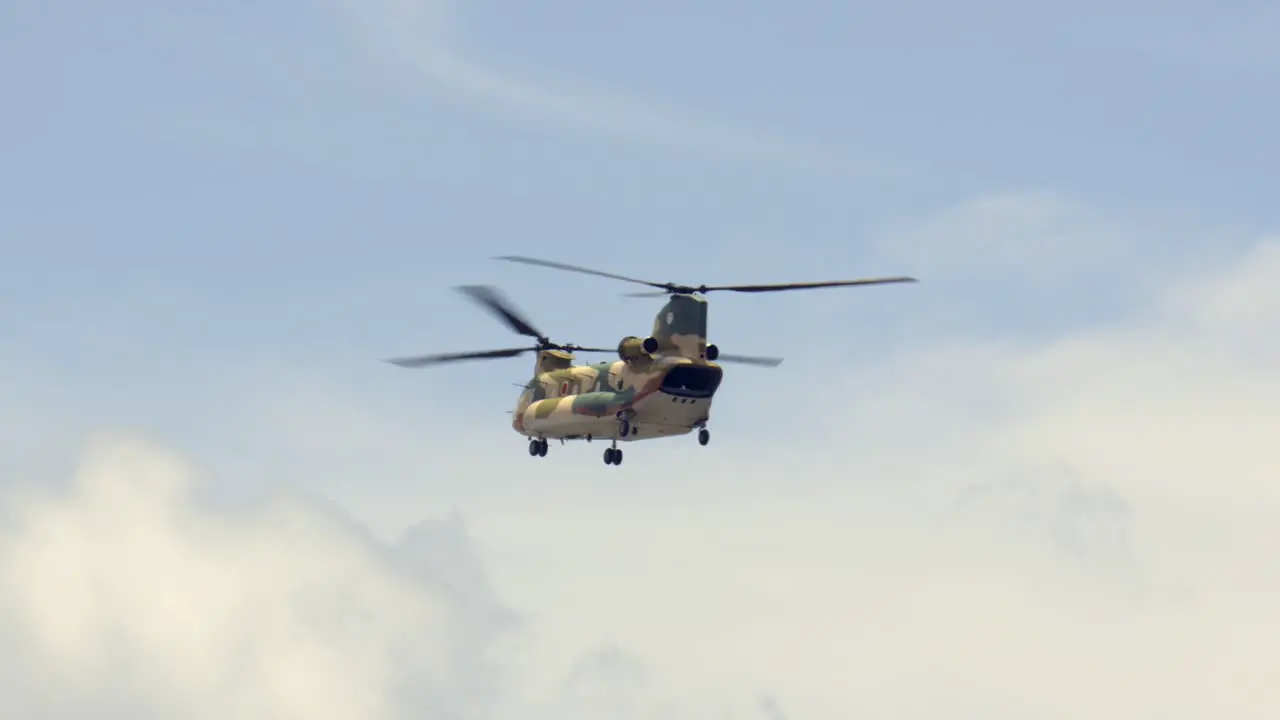 American Japanese USA Japan Chopper Helicopter camouflage take off at Okinawa International Airport Base twin propeller