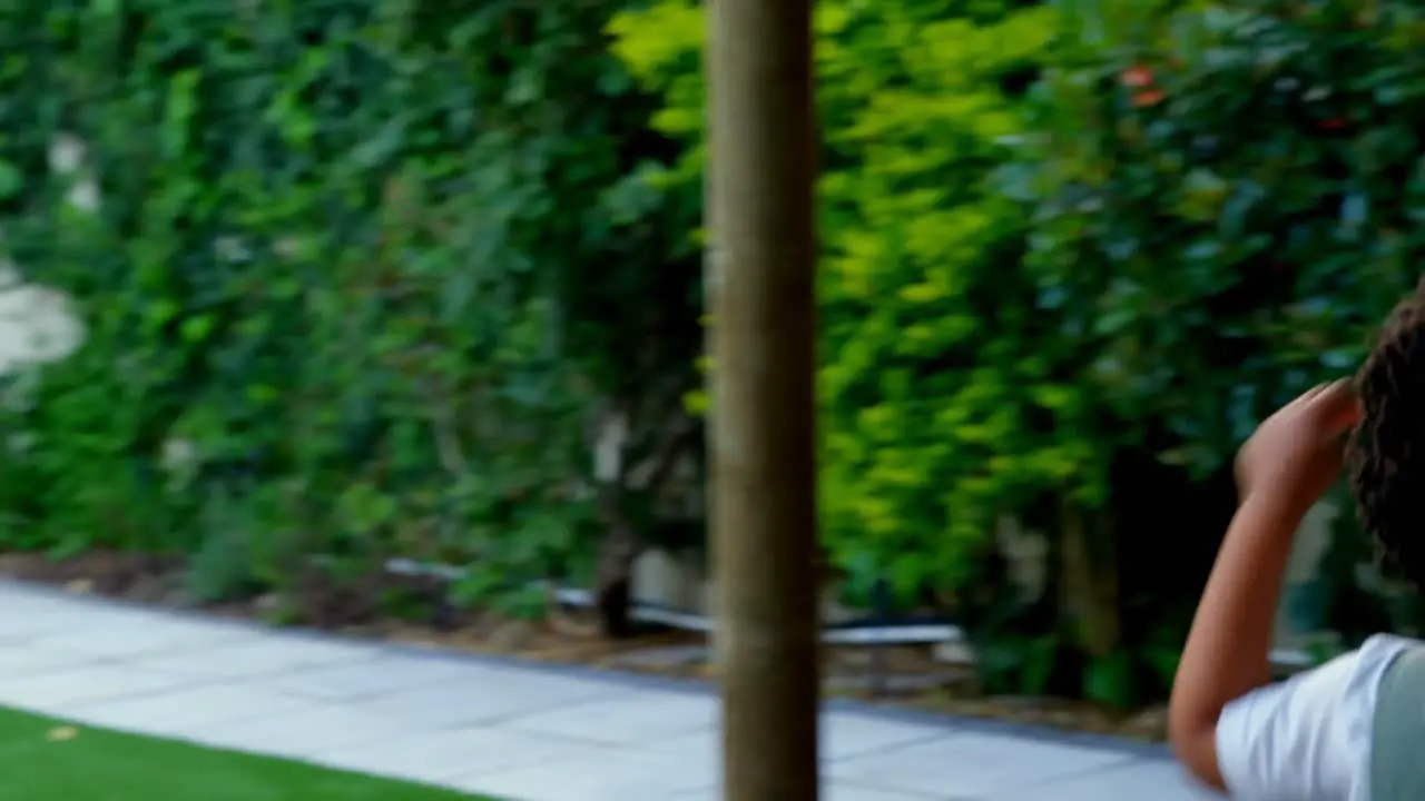 Side view of black young family having fun in back yard of their home 4k