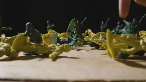 Tracking Shot of Multiple Toy Soldiers Being Knocked Down