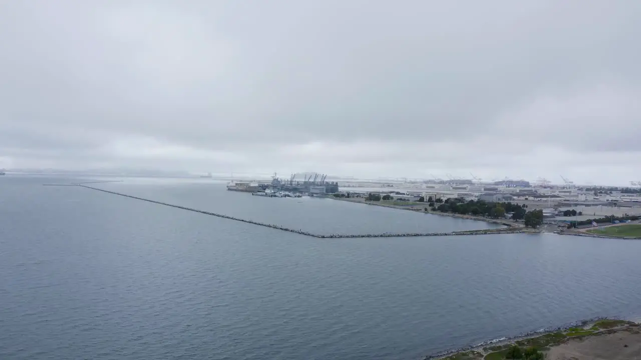 Small caps in the bay with ships and industrial businesses