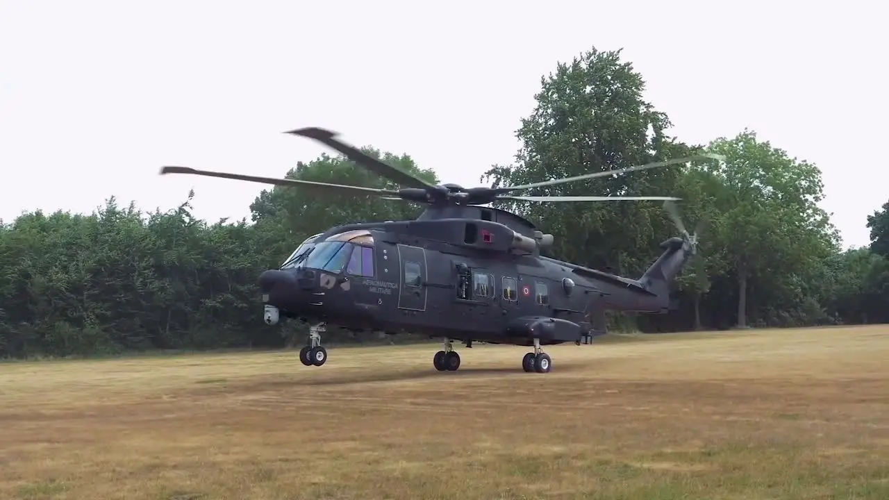 German Soldiers Participate In A Rescue Operation In A Field With A Military Helicopter Landing In The Background