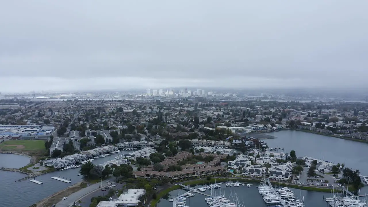 A large city in the background of the marina and sailboats