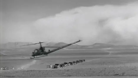 1950s Light Helicopter Flying Low Through the Desert