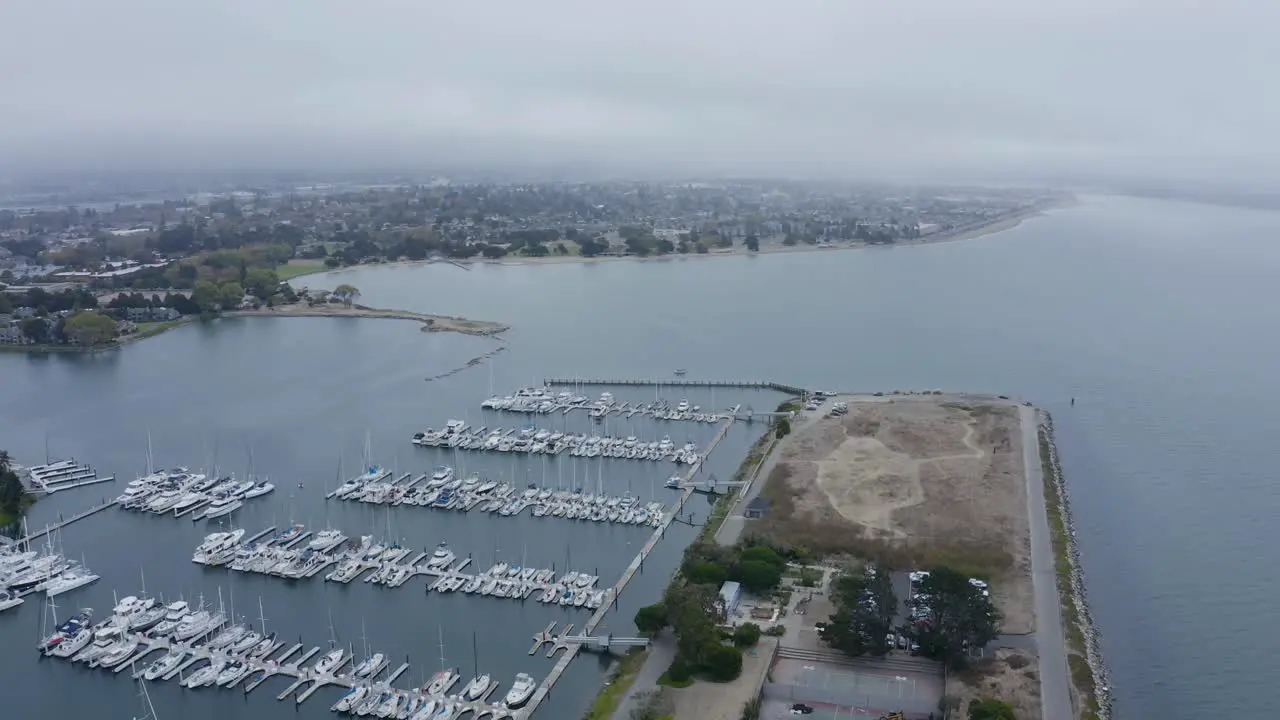 Sailboats in their slips in the marina on a rainy day