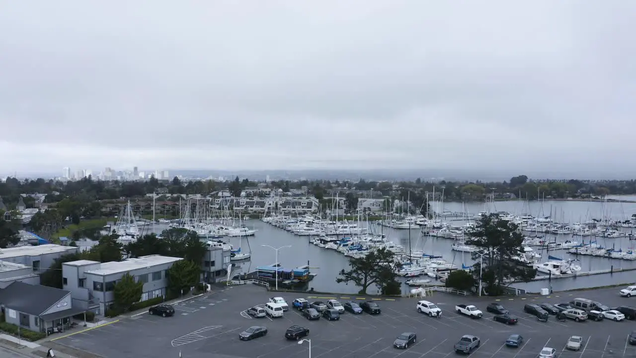 A large marina with many sail boats on a cloudy day