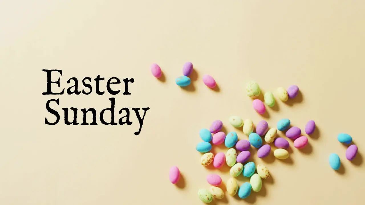 Animation of eastersunday text over colourful easter eggs on yellow background