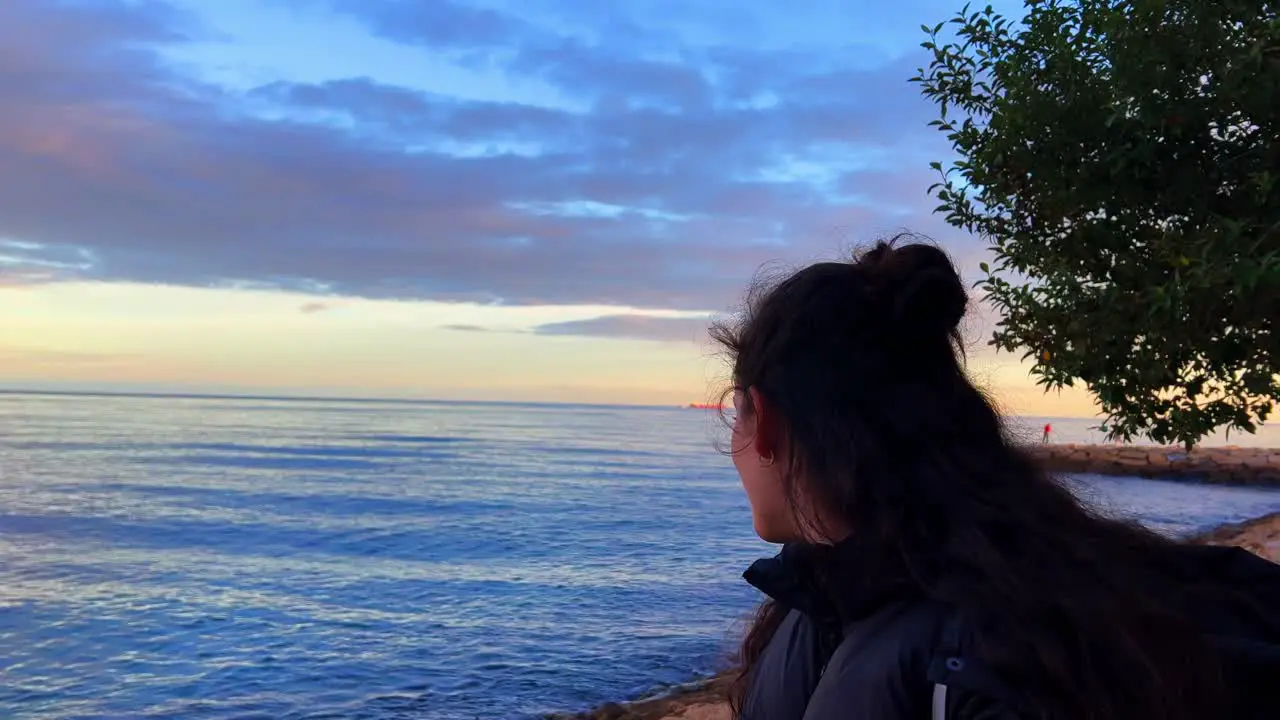 Beautiful lady looking at the sea in Alicante Spain during the day