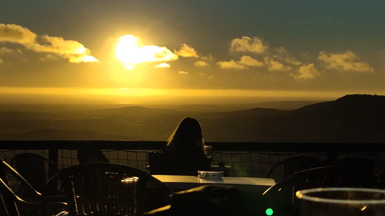 woman sitting on the terrace of a viewpoint