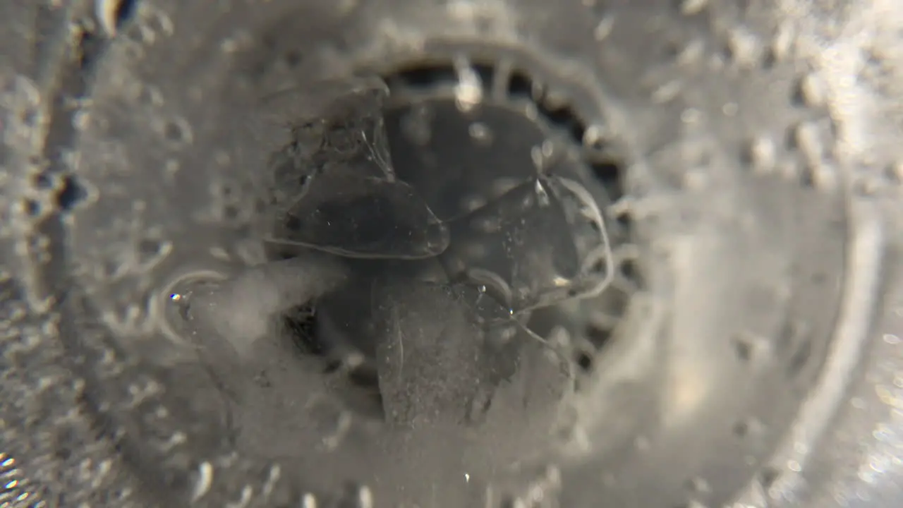 Gods eye view of clear sparkling drink with ice