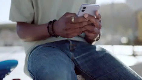 Black man hands and phone on city rooftop