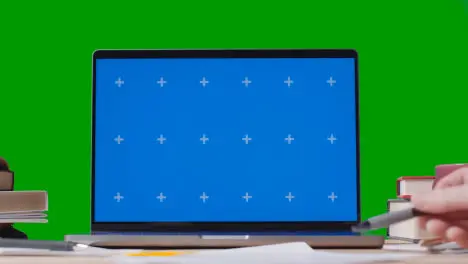 Blue Screen Laptop With Books On Table With Green Screen Background Education Concept 2