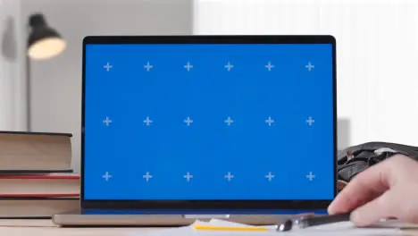 Blue Screen Laptop on Desk At Home With Student Working On It