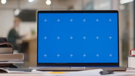 Blue Screen Laptop on Desk In University College Or School 3