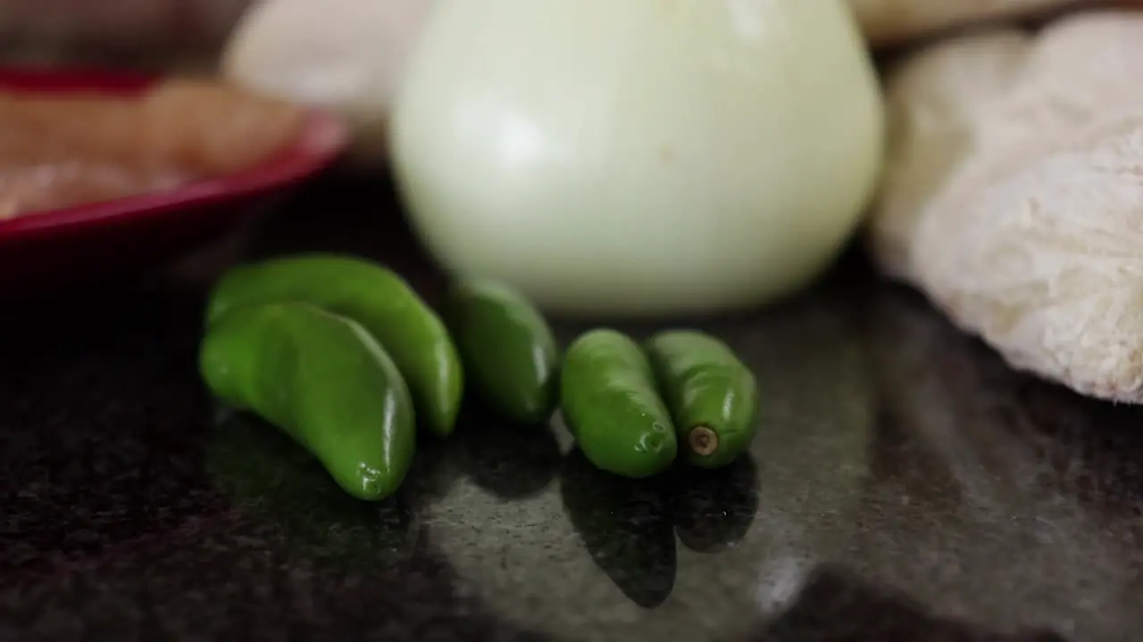 Close up of green chillies on a marble top