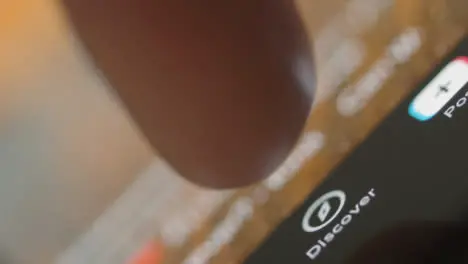 Tracking Close Up of Finger Pressing Tik Tok Discover Button on Phone