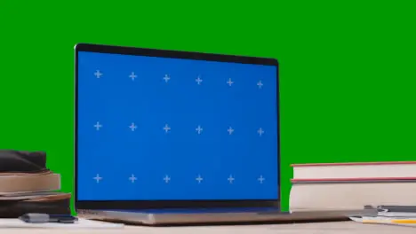 Blue Screen Laptop With Books On Table With Green Screen Background Education Concept 5