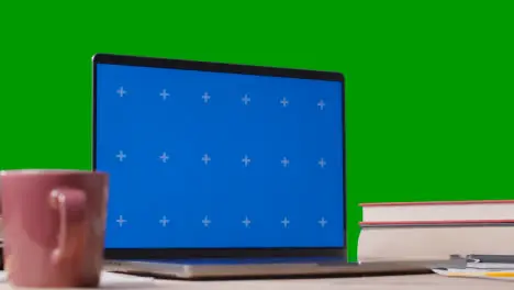 Blue Screen Laptop With Books On Table With Green Screen Background Education Concept 4