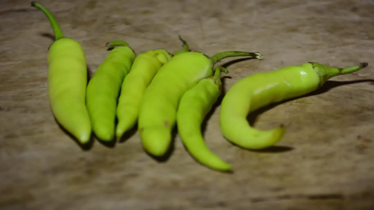 Hot peppers with spices on wooden table close up