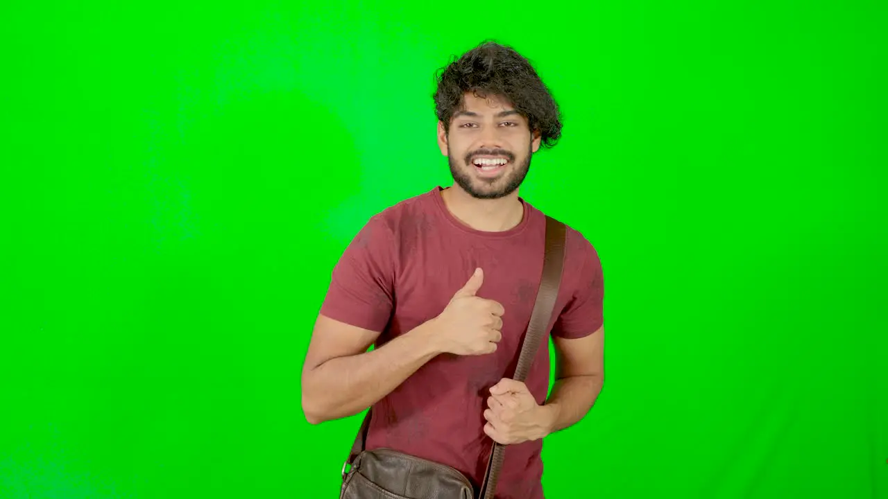 indian tourist standing and looking on camera with green background green screen