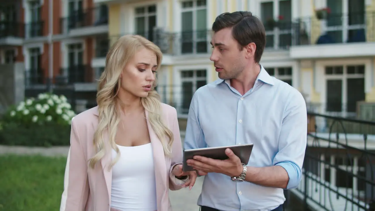 Entrepreneurs using tablet computer at street Business couple walking together