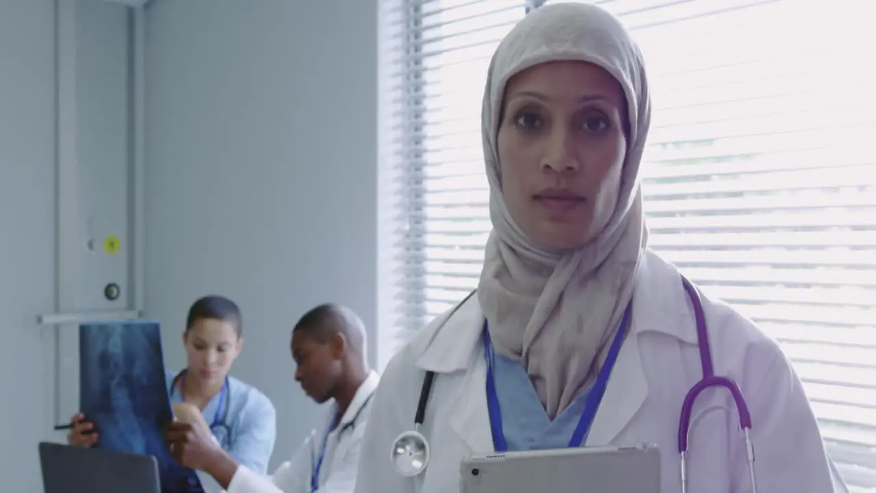 Front view of Middle-East female doctor using digital tablet in hospital