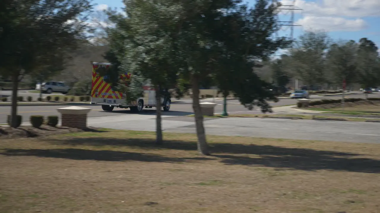 Ambulance passes by on a street on its way to the scene of an emergency