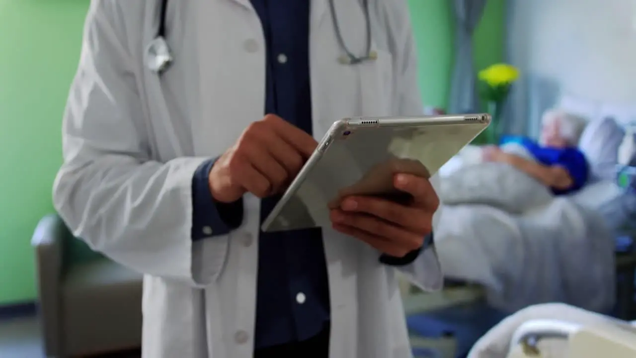 Male doctor using digital tablet 4k