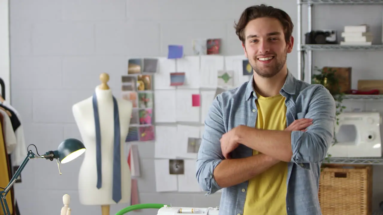 Portrait Of Smiling Male Student Or Business Owner Working In Fashion By Desk