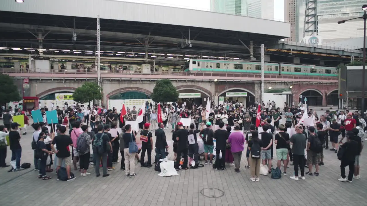 Demonstrators At The Shinbashi Station In Tokyo Japan Protesting In Solidarity With Hong Kong wide slowmo shot