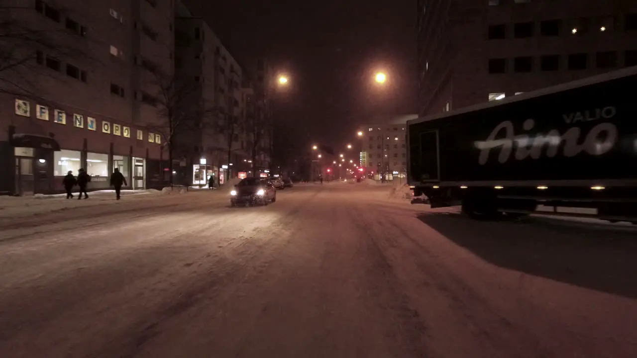 POV shot driving through downtown Helsinki with snow piled high