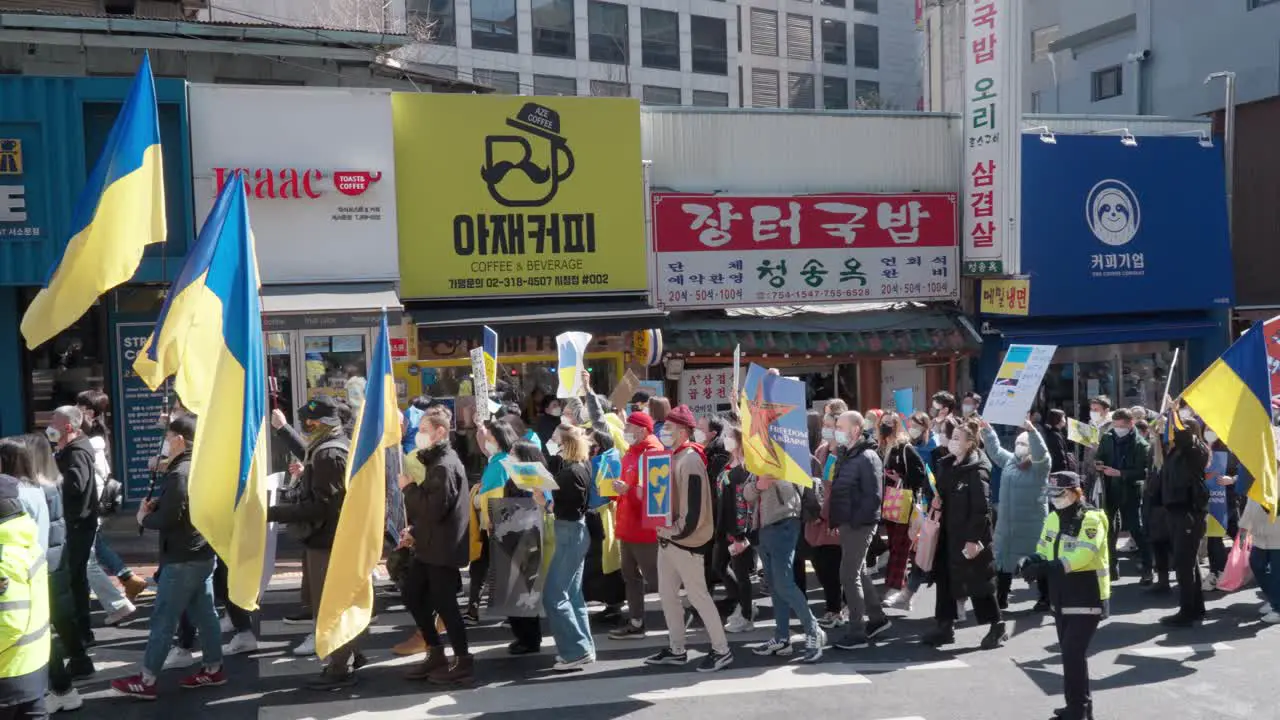 Ukrainian people with Posters and Flags During a March against Russian war in Ukraine