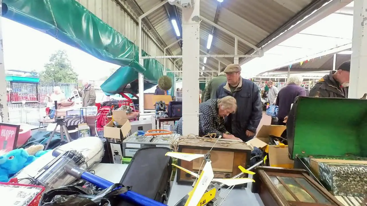 POV looking around British flea market at variety of disposable unwanted objects for a cheap saving