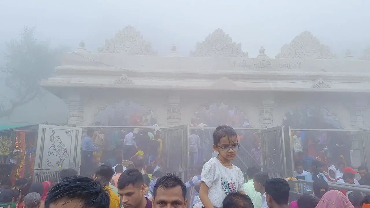 people coming out of temple at misty day from flat angle video is take at pawagarh gujrat india on July 10 2022