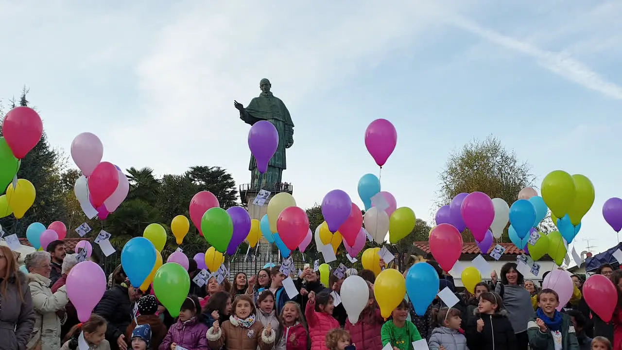 Group of children and balloons at San Carlone statue Arona Italy