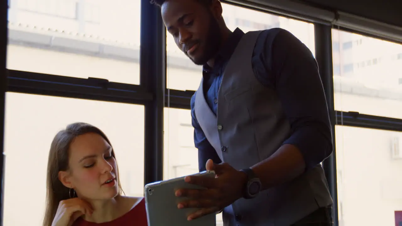 Front view of young cool mixed-race business team planning and working at desk of modern office 4k