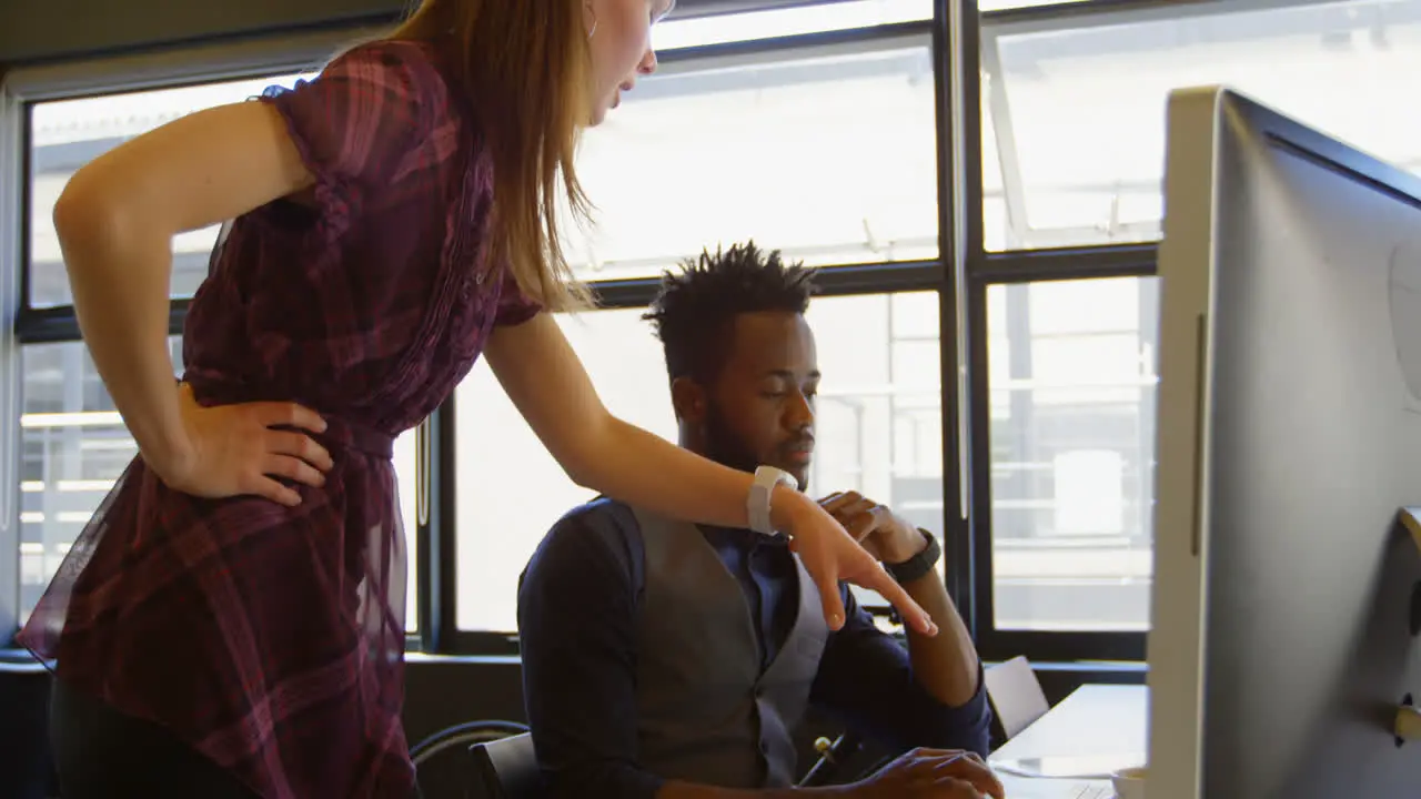 Side view of young cool mixed-race business team planning and working at desk in a modern office 4k