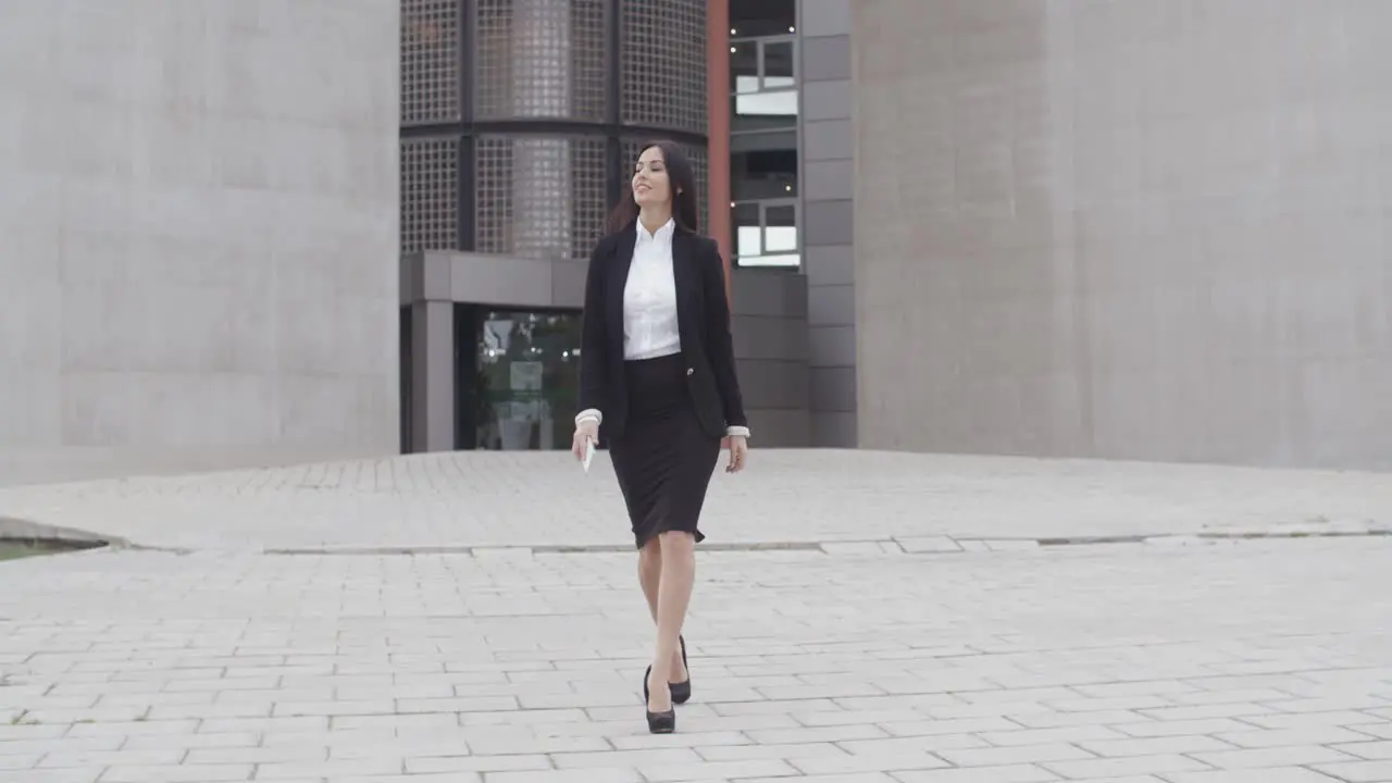 Young businesswoman walking towards the camera