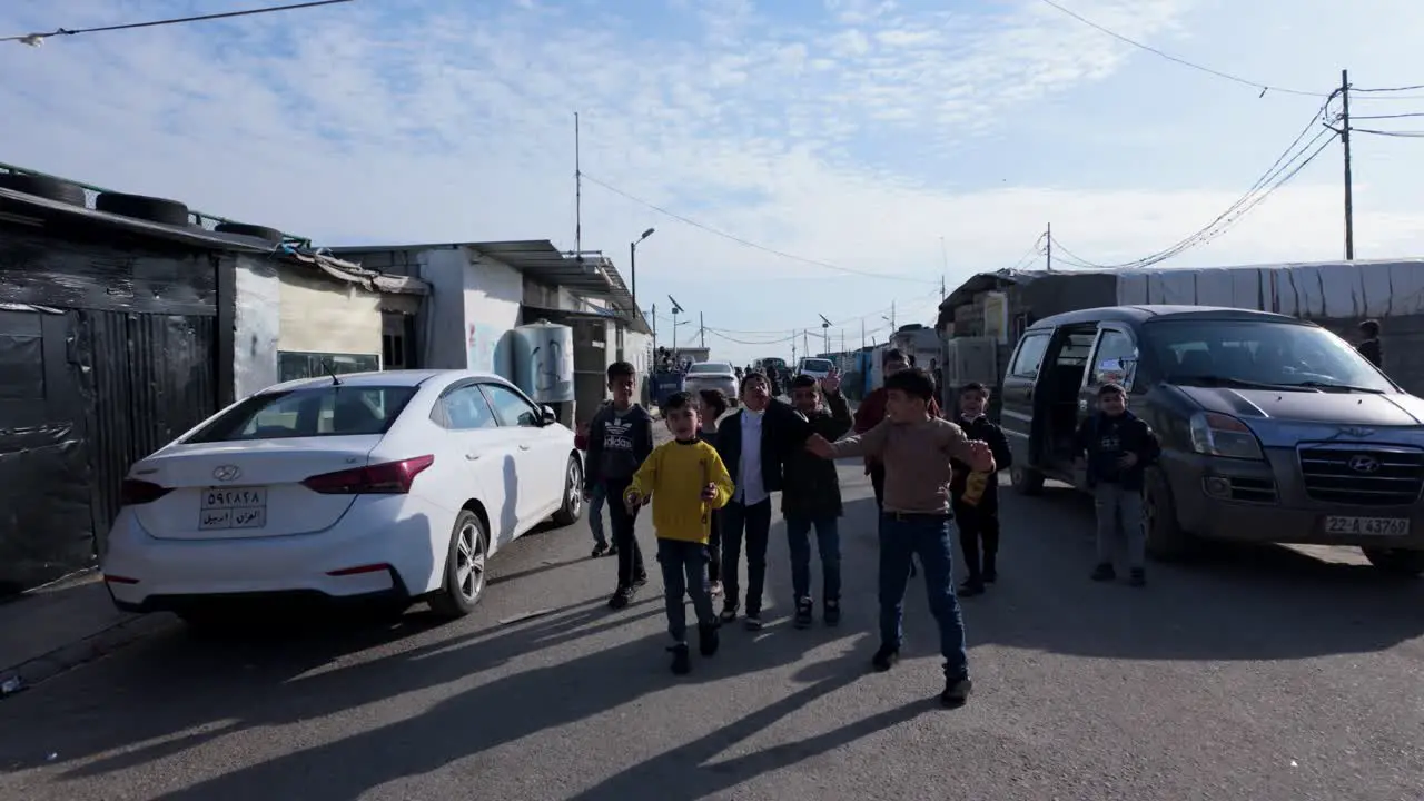 Children talk to visitors at the Harsham Refugee Camp near Erbil Iraq for internally displaced people IDP